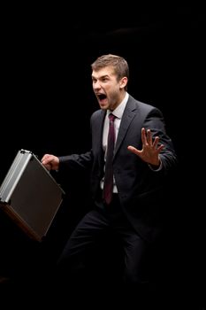 businessman with steel case over black