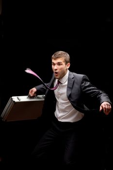 businessman with steel case over black