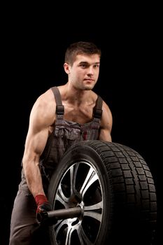 repairman with big wheel over black background