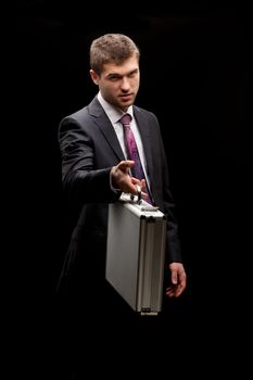 businessman with steel case over black