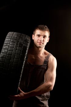 repairman with big wheel over black background