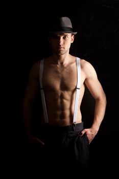 men in the hat on with suspenders over black