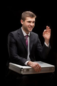 businessman with steel case over black