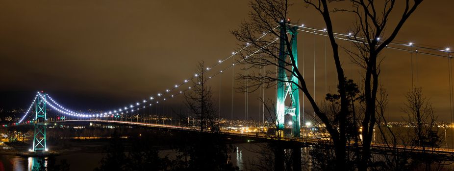 Lions Gate Bridge Over Burrard inlet in Vancouver Bc Canada at night Panorama