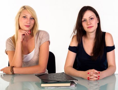 Two beautiful student girls getting ready for school isolated