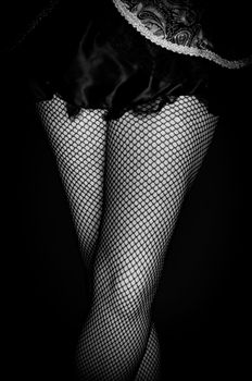 Legs of a youn woman against dark background closeup