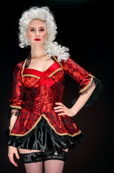 Young woman in baroque costume against dark background