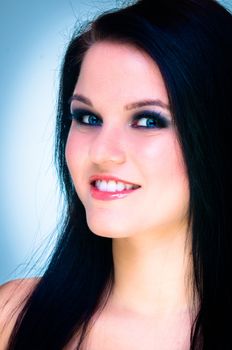 Closeup of a cheerful young woman smiling on white background