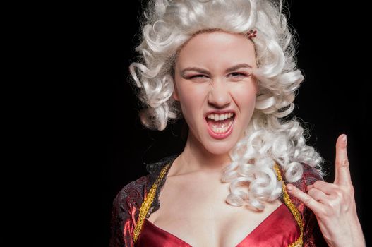 Young woman in baroque custome against dark background