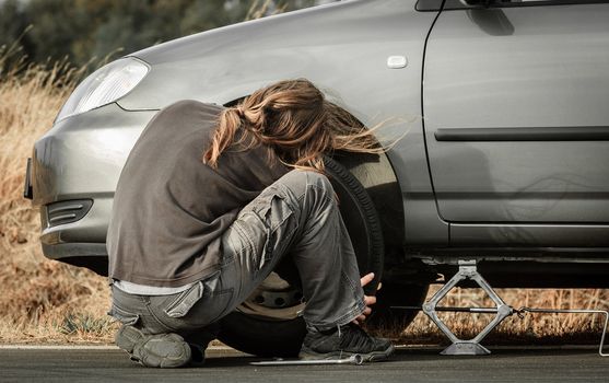 Young man in the middle of a car repair