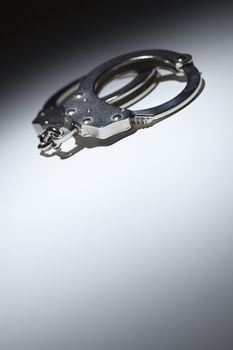 Abstract Pair of Handcuffs Under Spot Light With Room For Your Own Text.