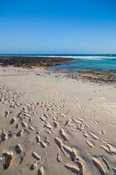 Exotic beach with sand and footprints on Lanzarote, Canary islands, Spain