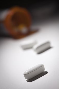 Medicine Bottle and Pills Under Spot Light Abstract.