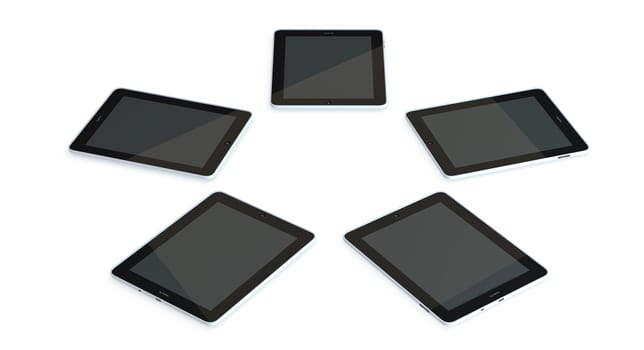 five tablet pc lie on the floor in a circle