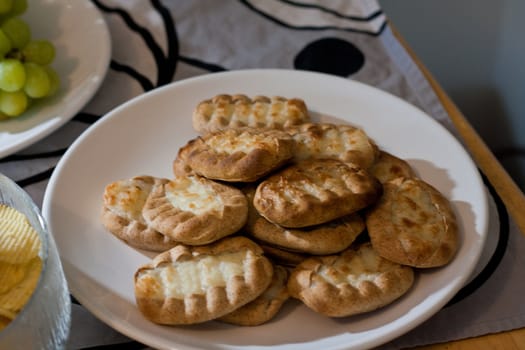 Carelian pies on a plate served with other food.