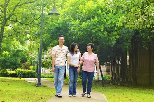 Asian adult having a outdoor walk with senior mother