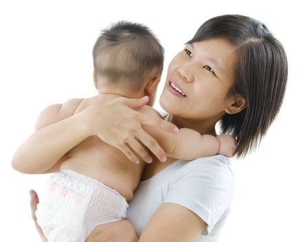 Pan Asian mother pampering her baby boy on white background