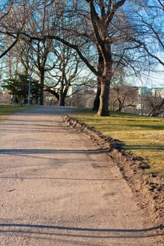 Gravel road in a park at spring time in Finland.