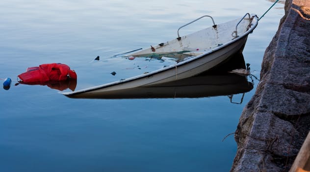 Sinkin boat at a lake attached to a dock