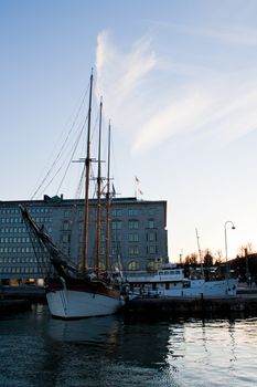 Old sailboat at a harbour attached to dock