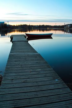 Small dock and a boat in Helsinki Finland at sunset