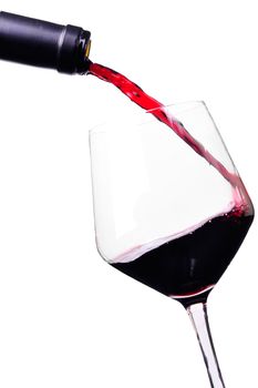 Bottle pouring red wine into a wine glass