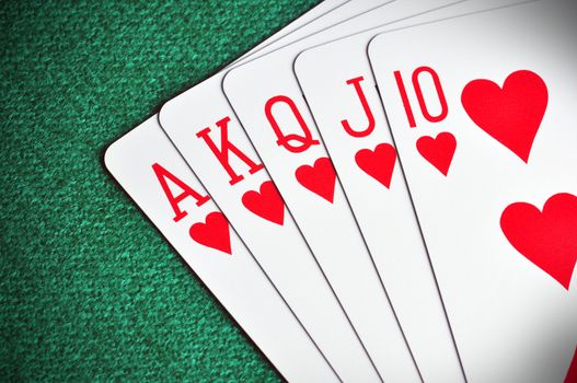 Royal Flush poker card sequence on a green table