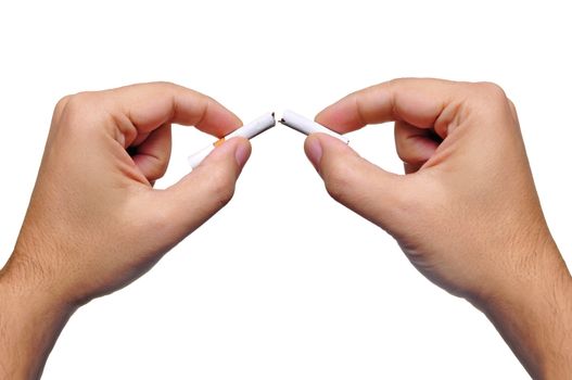 Two hands break a cigarette in half