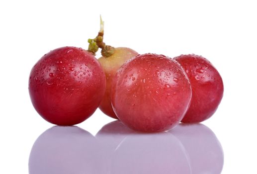 Macro of red grapes with a reflection underneath