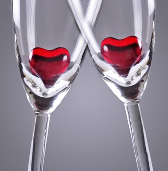 Red jelly hearts in champagne flutes, grey background