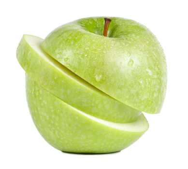 Isolated frontal shot of a fresh green sliced apple with stem and drops of water on it.