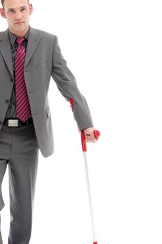 Disabled businessman with serious expression in a suit holding a crutch