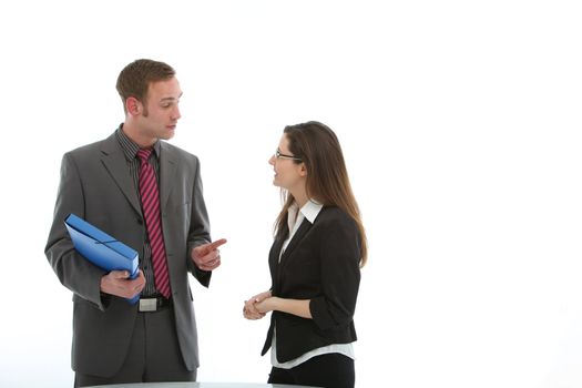 A businessman holding a blue folder in deep discussion with a female colleague, studio isolated on white