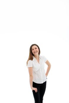 laughing woman in a white blouse and dark jeans, her right resting on her right thigh that is slight bent in front of her and her left hand at her back, on a white background