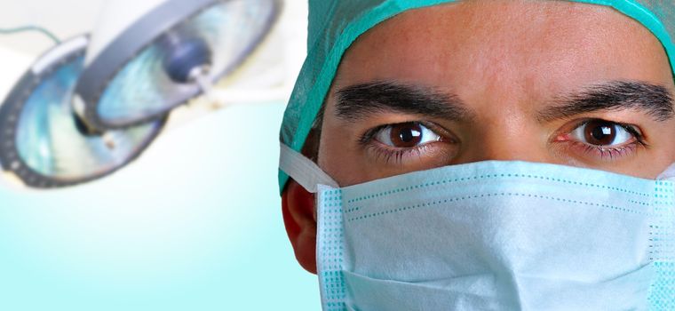 Closeup portrait of a surgeon with a operating room behind