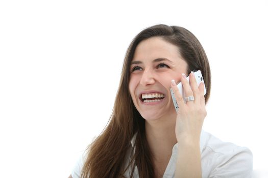 Attractive woman laughing merrily while speaking on her mobile phone