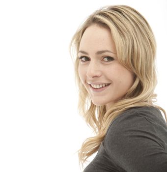 profile shot of a smiling blonde woman wearing a grey top on a white background