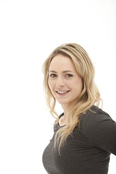 smiling blonde woman wearing a grey top on a white background