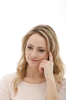 Closeup of a beautiful serious blonde woman with a wistful sad expression