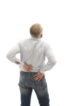 Senior man facing away from the camera holding hi slower back with both hands as though in pain