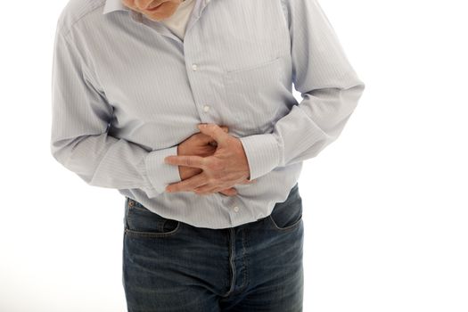 Man with abdominal pains or a stomach ache clutching his stomach with both hands