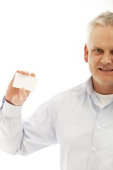 Middle-aged man in shirtsleeves holding up a blank business card isolated on white
