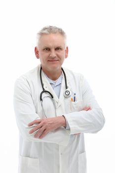 Senior male doctor or physician standing in a white labcoat with a stethoscope around his neck and his arms crossed on a white background