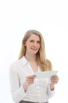 Attractive blonde woman smiling in anticipation at the thought of reading a letter which she is holding in her hands isolated on white