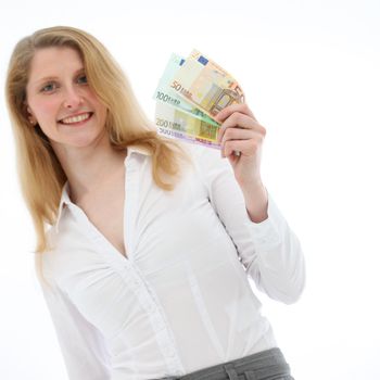 Closeup of a happy blonde woman holding a handful of fanned Euro notes of different values isolated on white