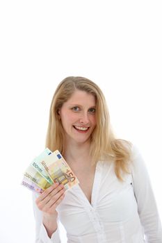 Wealthy happy woman smiling as she displays her winnings of a variety of different values of euro banknotes isolated on white