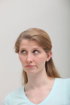 Studio shot of thoughtful woman on gray background