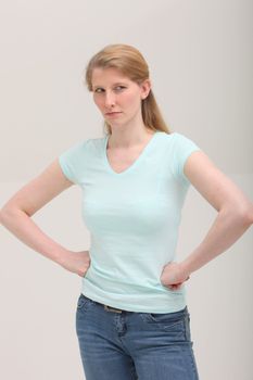 Studio shot of envious blonde woman on gray background