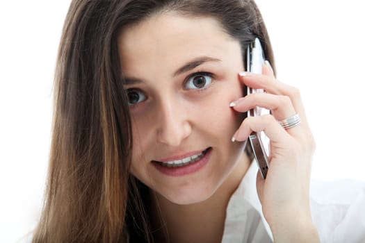 Closeup of the facial expression of an earnest young woman talking on mobile phone