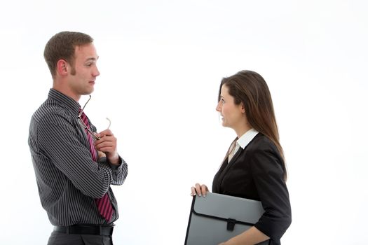 Stylish business partners standing sideways in deep conversation while sharing information and ideas